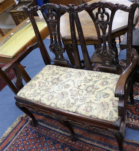 A Georgian style carved mahogany chair-back settee on claw and ball feet W.107cm